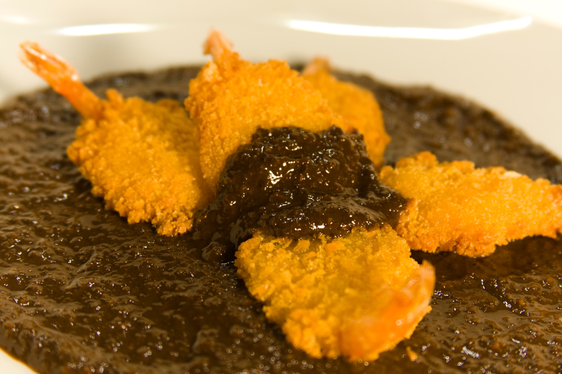Crispy shrimp served over rich mole sauce